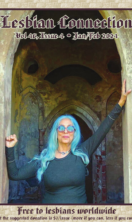 gothic castle doorway w/fluorescent blue-haired woman in matching sunglasses in doorway