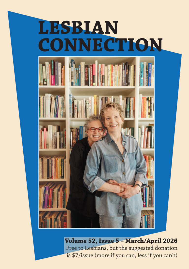 Photo of 2 women leaning into one another in front of a bookcase